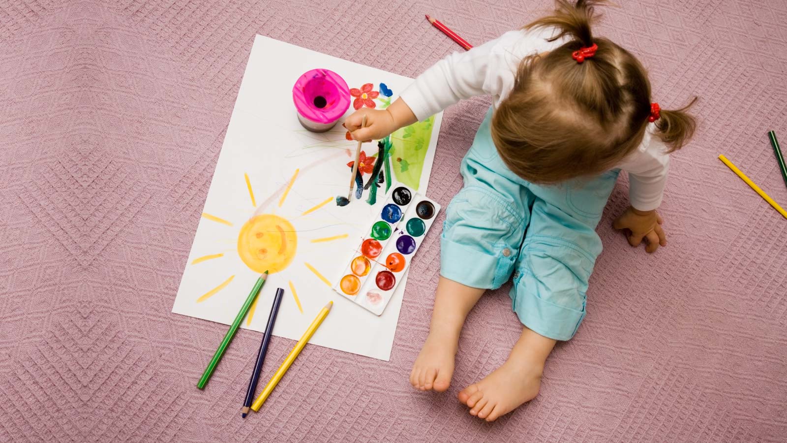 A child painting and listening to the music.