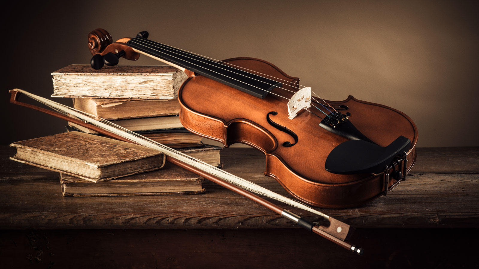 Classical violin with antique books.